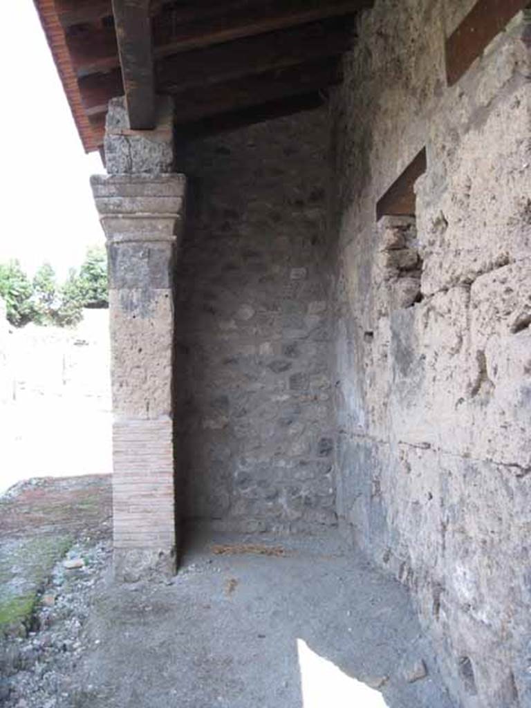 I.5.1 Pompeii. September 2010. Left (east) ante of restored portico looking east along Vicolo del Conciapelle towards unexcavated region.  Photo courtesy of Drew Baker.
