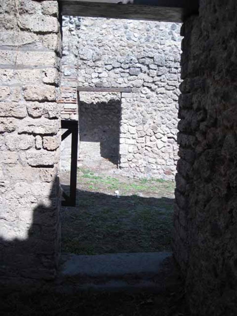 I.5.2 Pompeii. September 2010. Doorway looking east towards shop-room, from room on west side of it. Photo courtesy of Drew Baker.