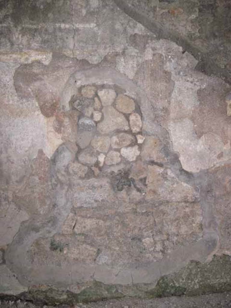 I.5.2 Pompeii. September 2010. East wall, left of centre with fresco work, in small room. Photo courtesy of Drew Baker.