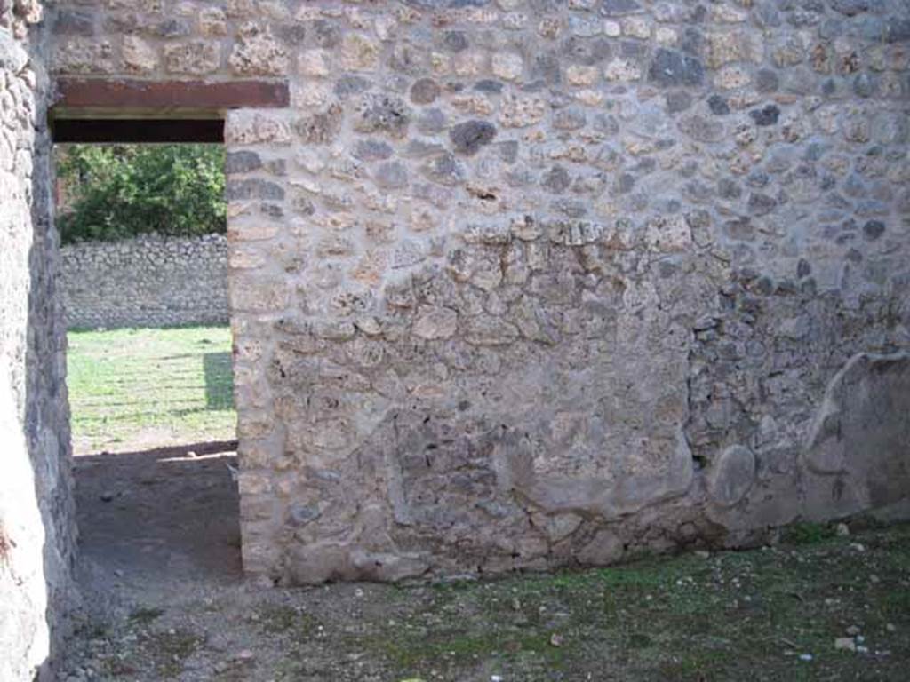 I.5.2 Pompeii. September 2010. Looking at south wall of room in north-west corner of peristyle, with doorway to north portico. Photo courtesy of Drew Baker.