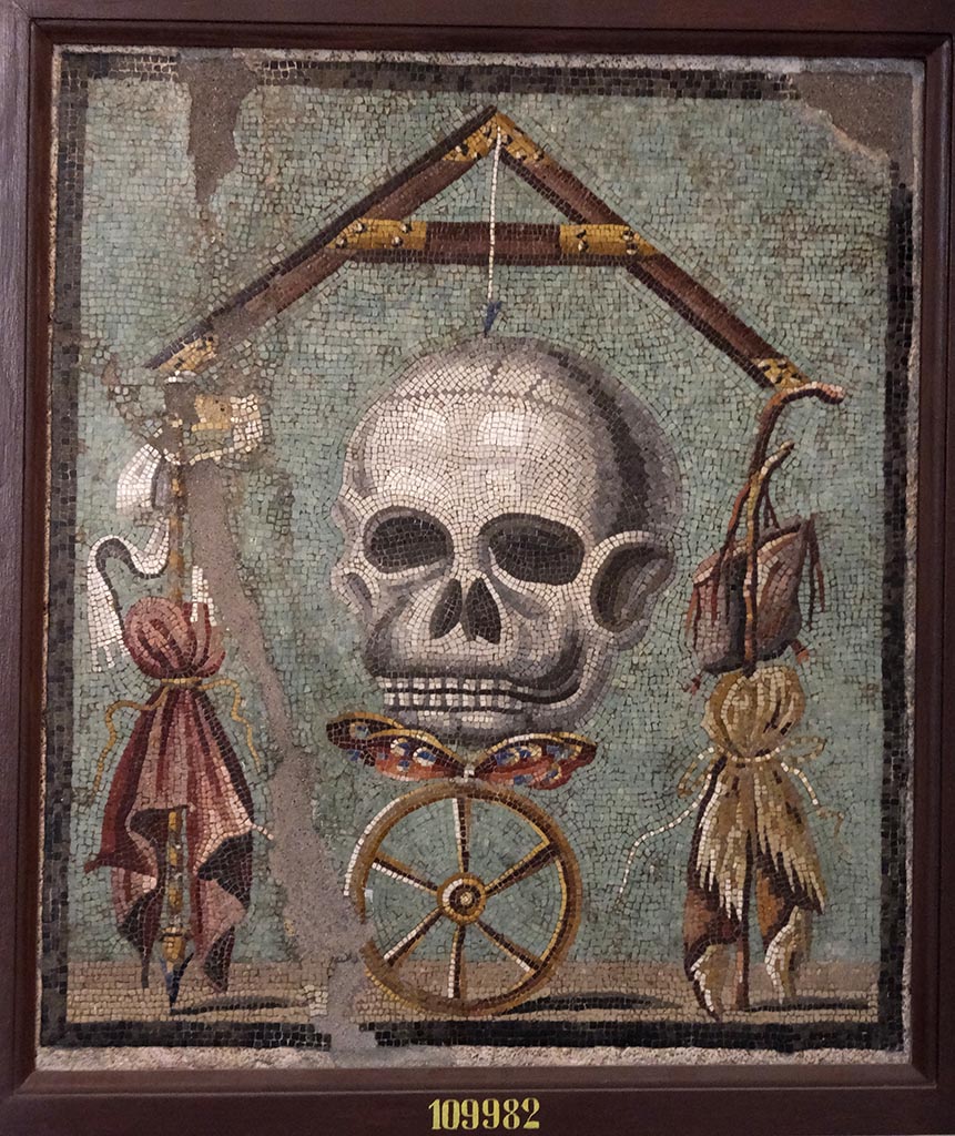 1.5.2 Pompeii. Triclinium in peristyle garden. Mosaic of a skull that formed the top of the triclinium table. 
Now in Naples Archaeological Museum, inventory number 109982.