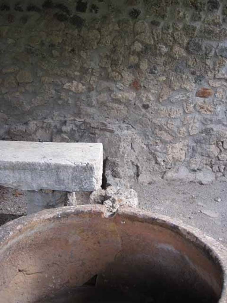 I.5.2 Pompeii. September 2010. Looking east towards remains of southern wall between fourth and third divided compartments, in relation to pot. 
Photo courtesy of Drew Baker.