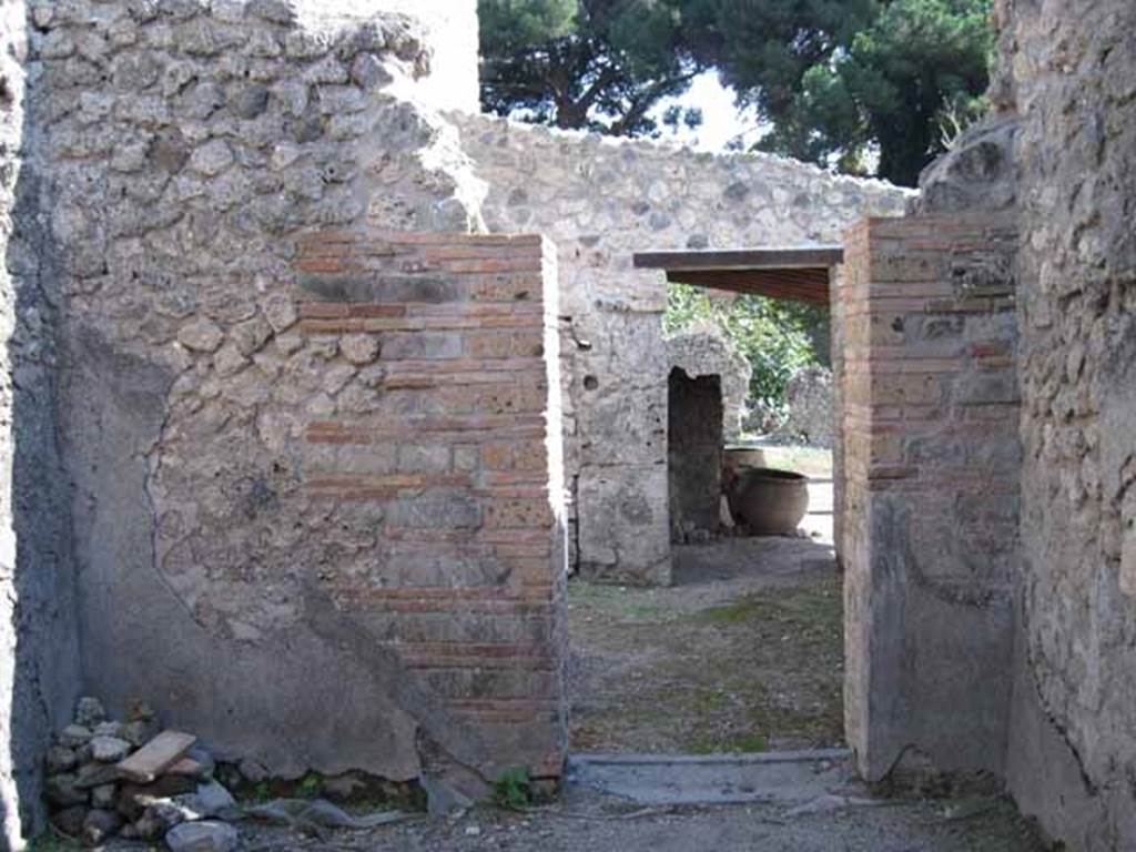 I.5.2 Pompeii. September 2010. Looking south from room with window, into room with steps and towards doorway to eastern portico. Photo courtesy of Drew Baker.
.