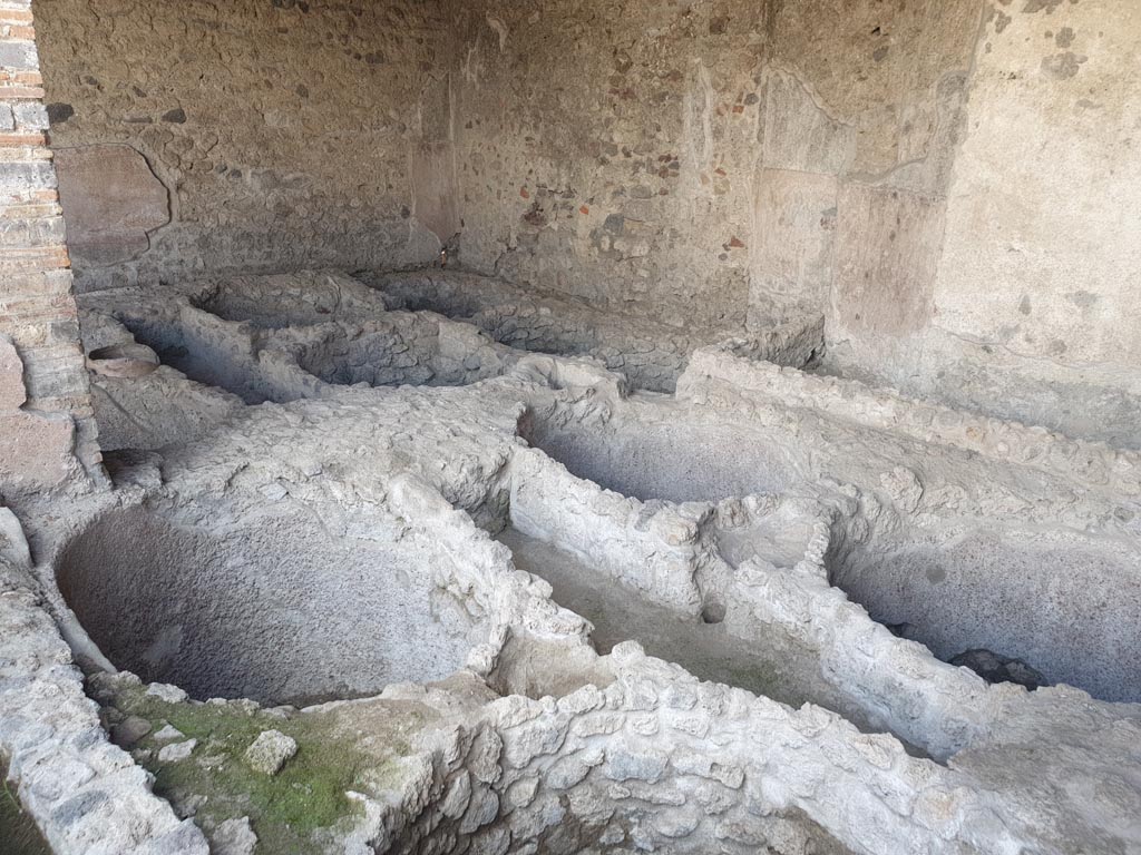 I.5.2 Pompeii. August 2023. Looking south-east towards south wall of industrial room. Photo courtesy of Maribel Velasco.