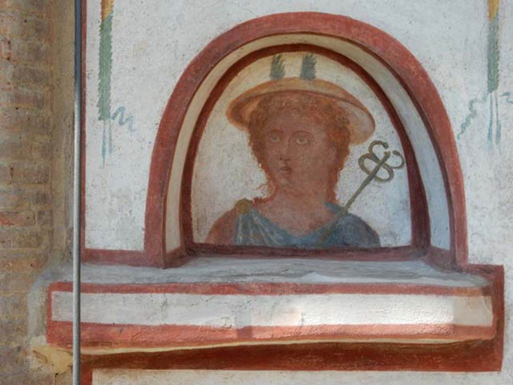 I.6.2 Pompeii. May 2016. Detail of painted Mercury in the arched niche of the lararium on west wall near portico.  
Photo courtesy of Buzz Ferebee.