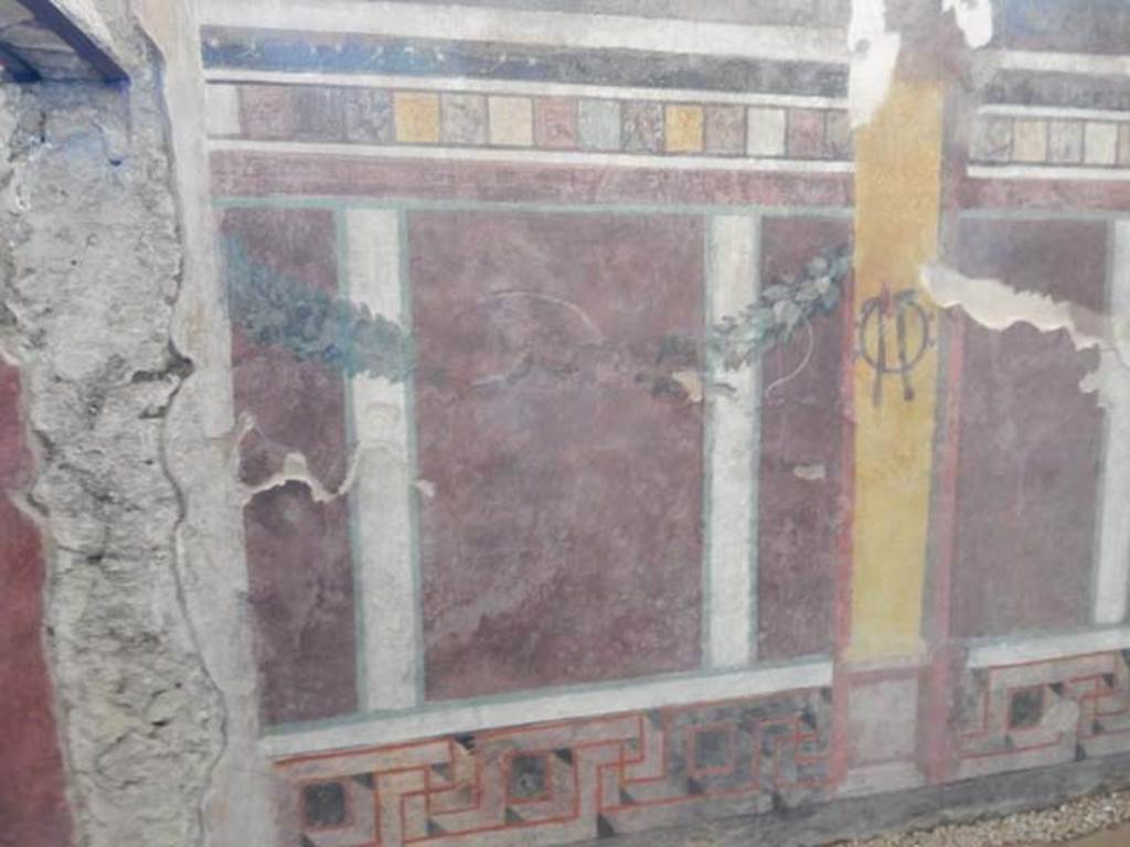 I.6.2 Pompeii. May 2016. South end of west wall, near doorway to oecus, on left. 
Photo courtesy of Buzz Ferebee.