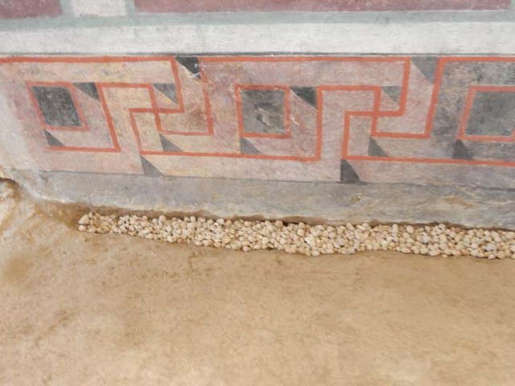 I.6.2 Pompeii. May 2016. Detail from zoccolo, or lower part, of south end of west wall of east wing. Photo courtesy of Buzz Ferebee.