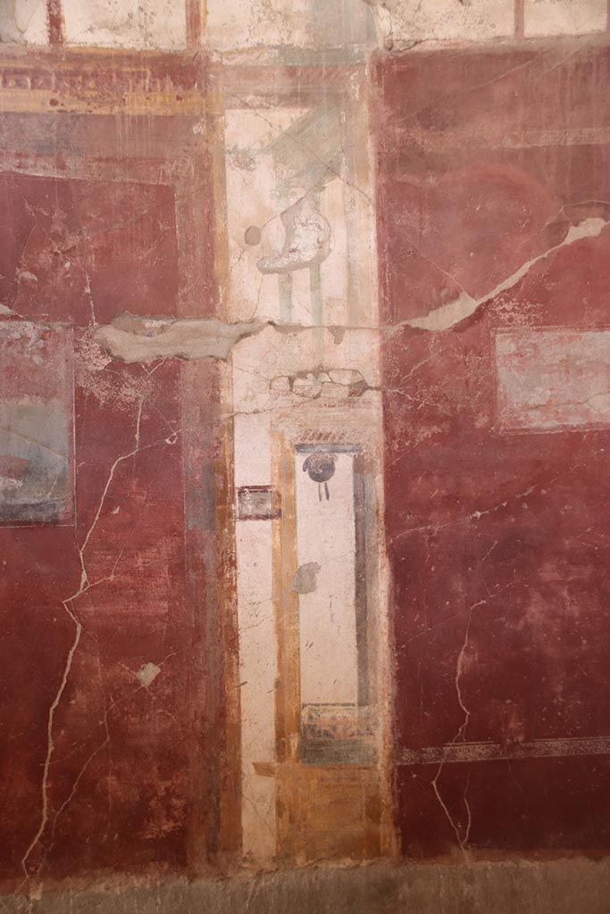 I.6.4 Pompeii. October 2024. 
Room 2, west wall, detail of painted decoration on north (right) side of central painting. 
Photo courtesy of Klaus Heese.