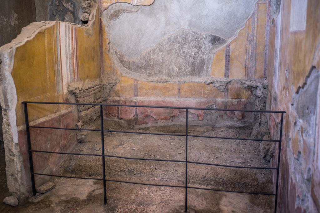 I.6.4 Pompeii. December 2021. 
Room 4, looking towards north and east wall, with site of bed, 2.31m long x 1.32m wide. Photo courtesy of Johannes Eber.
This is a similar photo to Fig. 512 (on page 450, and a reconstruction of the bed and box shown in Fig.513), described by Spinnazzola as – 
“Letto a spalliera di legno intagliato a doppia fila di rettangoli corniciati (impronte nella cenere), e cassetta sottostante (impronta) Primo cubiculo ad oriente.”
“Carved wooden backrest bed with double row of framed rectangles (impressions in the ash), and box underneath (impression). First cubiculum to the east”.
See Spinazzola V., 1953. Pompei alla luce degli Scavi Nuovi di Via dell’Abbondanza (anni 1910-1923). Roma: La Libreria della Stato, (p.447, and p.450).