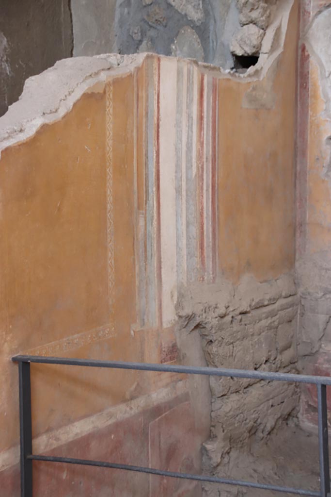 I.6.4 Pompeii. October 2022. 
Room 4, detail from north wall at east end. Photo courtesy of Klaus Heese. 
This shows part of the remaining “carved double row of framed rectangles” from the wooden bed, still visible in the ash.