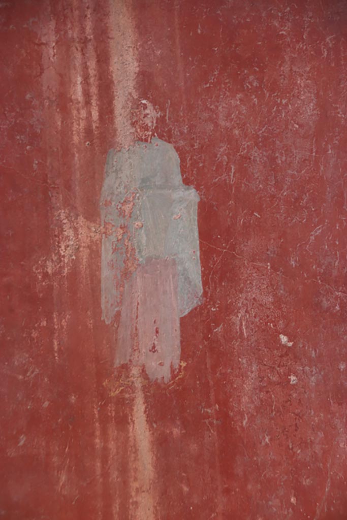 I.6.4 Pompeii. October 2022. 
Room 5, detail of painted figure from west end of north wall. Photo courtesy of Klaus Heese.