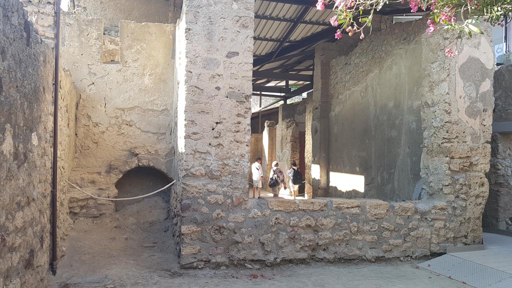 I.6.4 Pompeii. August 2023. 
Looking north towards room 14, stairs to upper floor, on left, and window into tablinum, on right. Photo courtesy of Maribel Velasco.