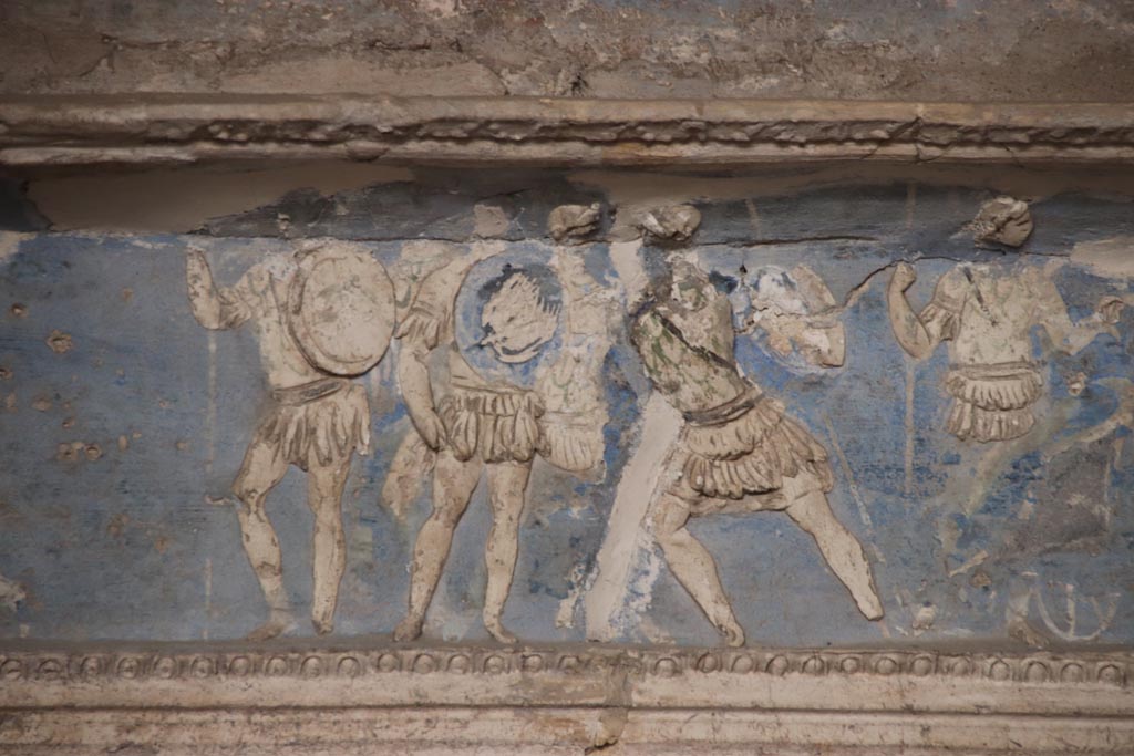 I.6.4 Pompeii. October 2023. Room 16. Group of Achaean warriors.
Detail from frieze on south wall towards the west end, Photo courtesy of Klaus Heese.