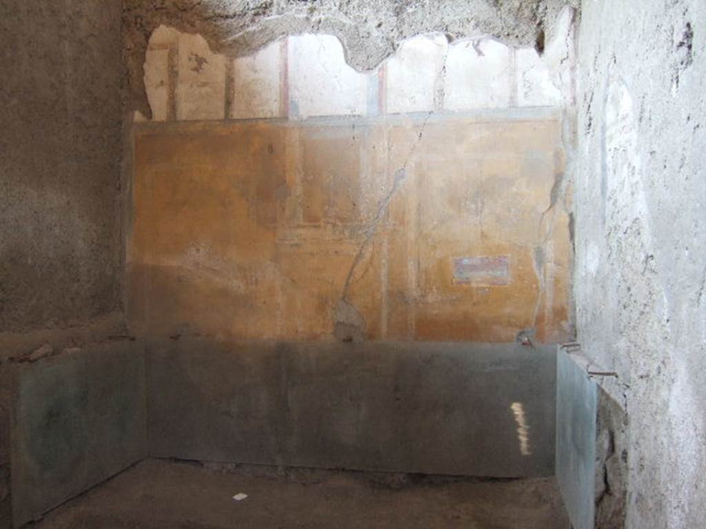 I.6.4 Pompeii. December 2005. Room 17, north wall and site of impression of a bed, 2.35m long x 1.24 wide.
This is a similar photo to Fig. 510 (on page 449, and a reconstruction of the bed shown in Fig.511), described by Spinazzola as – 
“Cubicolo con letto a spalliera intarsiata di riquadri in osso. Cenere con impronte delle antiche forme rassodata in sito. Impronte del telaio. Cubicolo a nord”.  
 (Cubiculum with backrest bed inlaid with bone panels. Impression of the ancient form hardened in the ash, in situ. Imprint of the frame. Cubiculum to the north).
See Spinazzola V., 1953. Pompei alla luce degli Scavi Nuovi di Via dell’Abbondanza (anni 1910-1923). Roma: La Libreria della Stato, (p.447, and p.449).