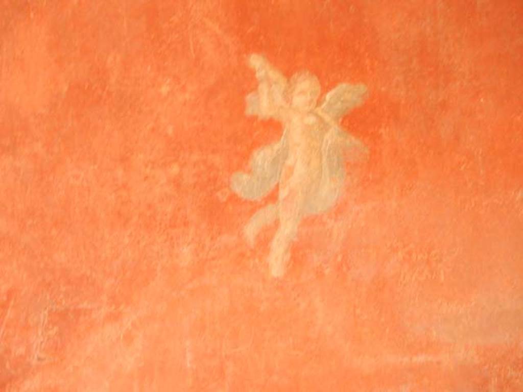 I.6.7 Pompeii. May 2016. Detail of painted flying cupid from south end of east wall.   Photo courtesy of Buzz Ferebee.