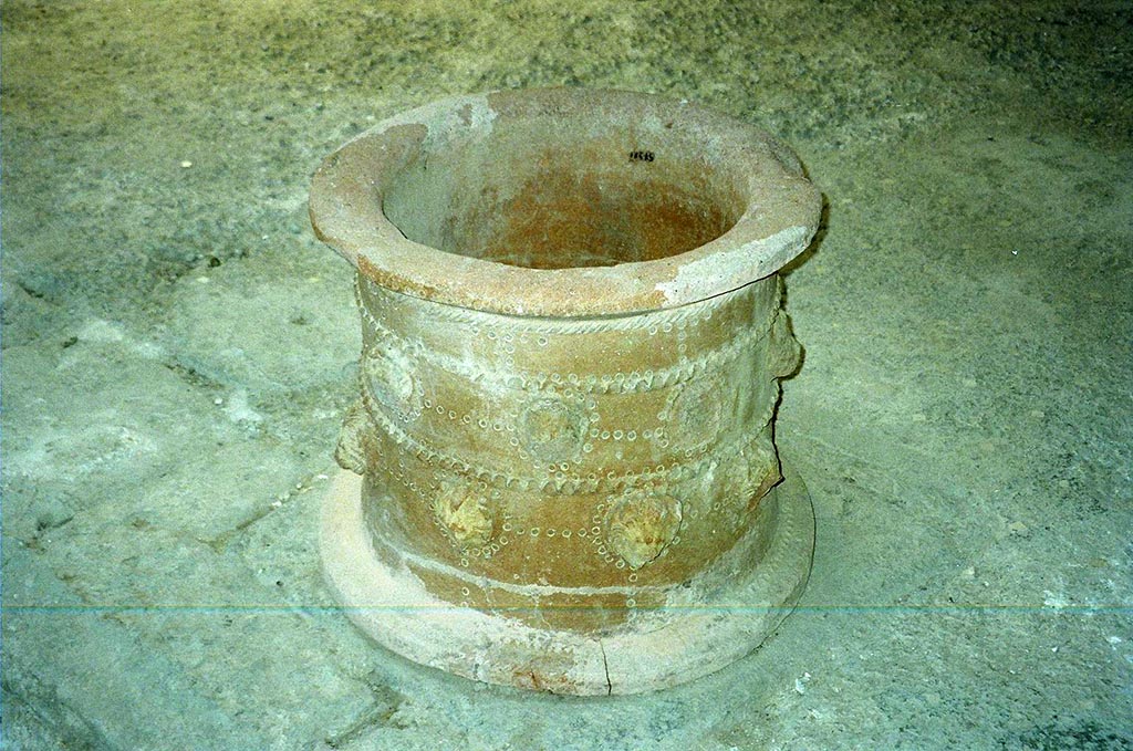I.6.11 Pompeii. June 2010. 
Terracotta puteal, decorated with heads of lions, originally found on the east side of the peristyle, but now in atrium.
See Bragantini, de Vos, Badoni, 1981. Pitture e Pavimenti di Pompei, Parte 1. Rome: ICCD. (p.36).
See Jashemski, W. F., 1993. The Gardens of Pompeii, Volume II: Appendices. New York: Caratzas. (p.36). Photo courtesy of Rick Bauer.