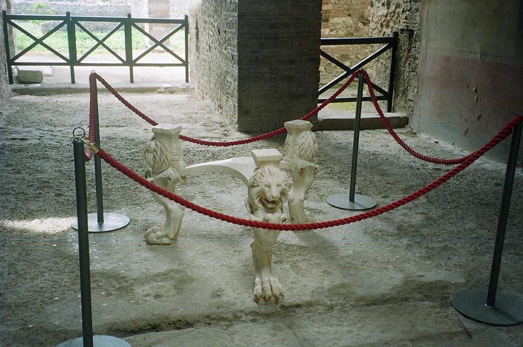 I.6.11 Pompeii. May 2010. Marble tripod table legs with lion’s heads and paws. 
The inscription on the top of each leg identifies the table as having belonged to Casca Longus. 
He was the first assassin to strike Caesar in the Senate in 44BC. He died in 42BC along with Brutus at the Battle of Philippi in Macedonia. 
His lands and possessions were confiscated and publicly sold. 
The table was then or sometime later bought by the owner of this house. Photo courtesy of Rick Bauer.