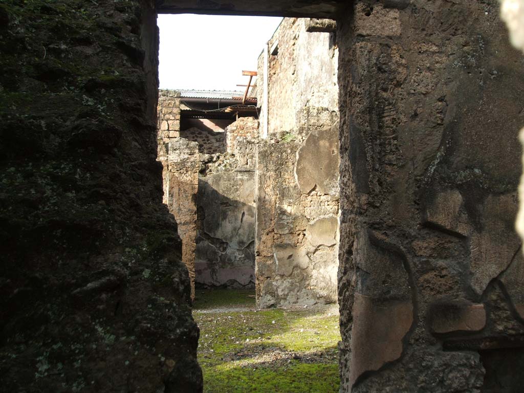 I.6.13 Pompeii. December 2004. Looking across room on east side of entrance with stairs (I.6.14) against west wall. 
Looking north-east towards doorway of cubiculum (5).