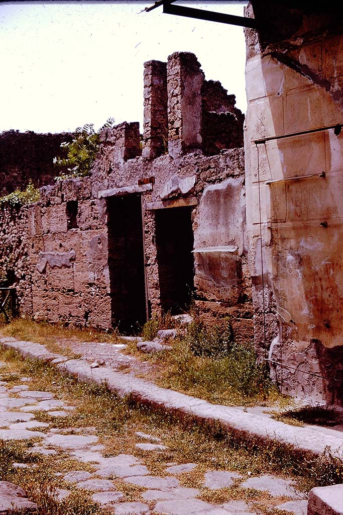 I.6.13 and I.6.14 Pompeii. 1961. 
Entrance doorways on north side of Vicolo del Menandro. Photo by Stanley A. Jashemski.
Source: The Wilhelmina and Stanley A. Jashemski archive in the University of Maryland Library, Special Collections (See collection page) and made available under the Creative Commons Attribution-Non Commercial License v.4. See Licence and use details.
J61f0349