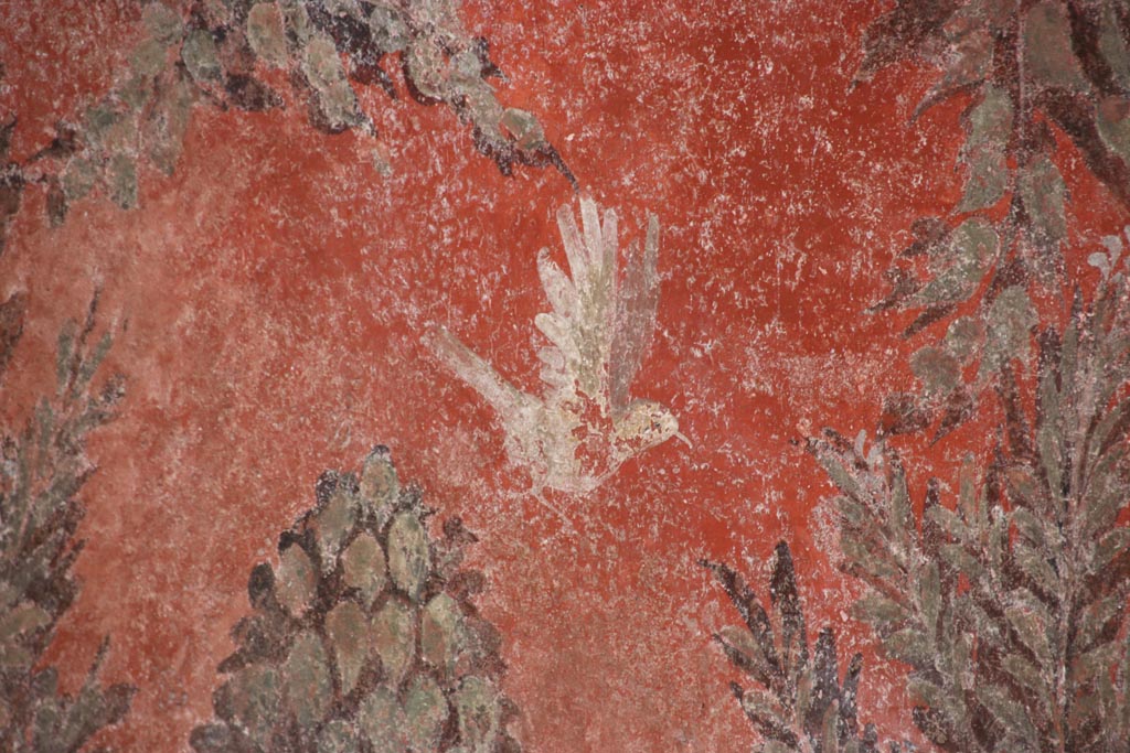 I.6.15 Pompeii. October 2023. 
Room 9, detail of painted bird on south side of window in east wall of small garden. Photo courtesy of Klaus Heese.