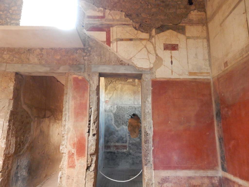 I.6.15 Pompeii. June 2019. Room 4, north-east corner of atrium, with doorway to corridor 7, on left.
The doorway to room 12 is centre right. Photo courtesy of Buzz Ferebee.