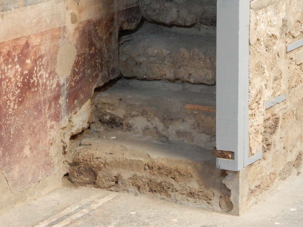I.6.15 Pompeii. June 2019. Room 3, detail of lower stairs to upper floor in north-west corner of atrium.
Photo courtesy of Buzz Ferebee.
