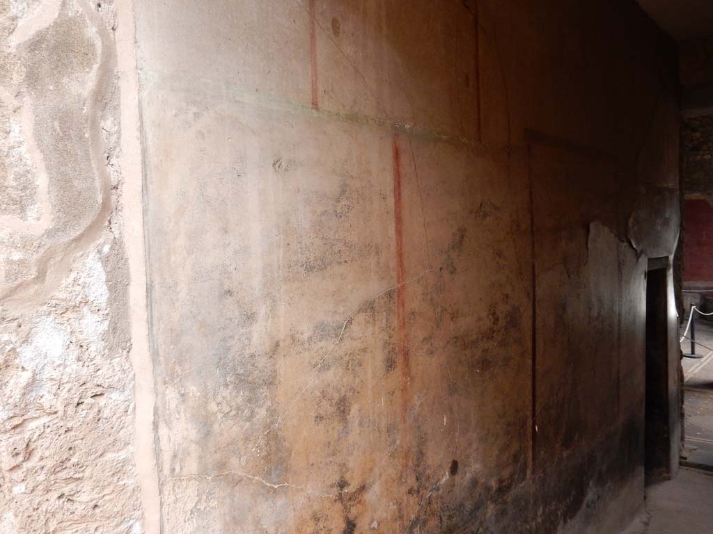 I.6.15 Pompeii. June 2019. Corridor 7, looking south along east wall towards atrium.
On the right is the corridor doorway into room 12, a triclinium. Photo courtesy of Buzz Ferebee.