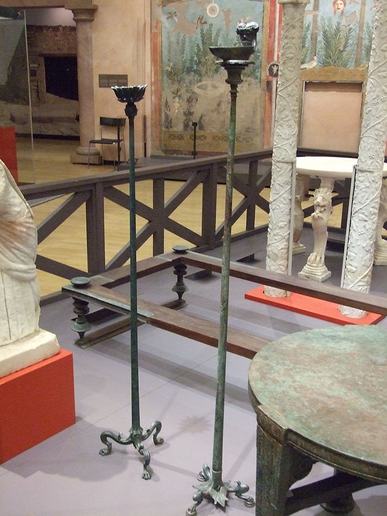 I.7.1 Pompeii. Bronze candelabrum (on right) with Ammon lamp soldered to top. 
SAP 3244 (Candelabrum) and 3244a (Lamp).
Photographed at “A Day in Pompeii” exhibition at Melbourne Museum. September 2009.