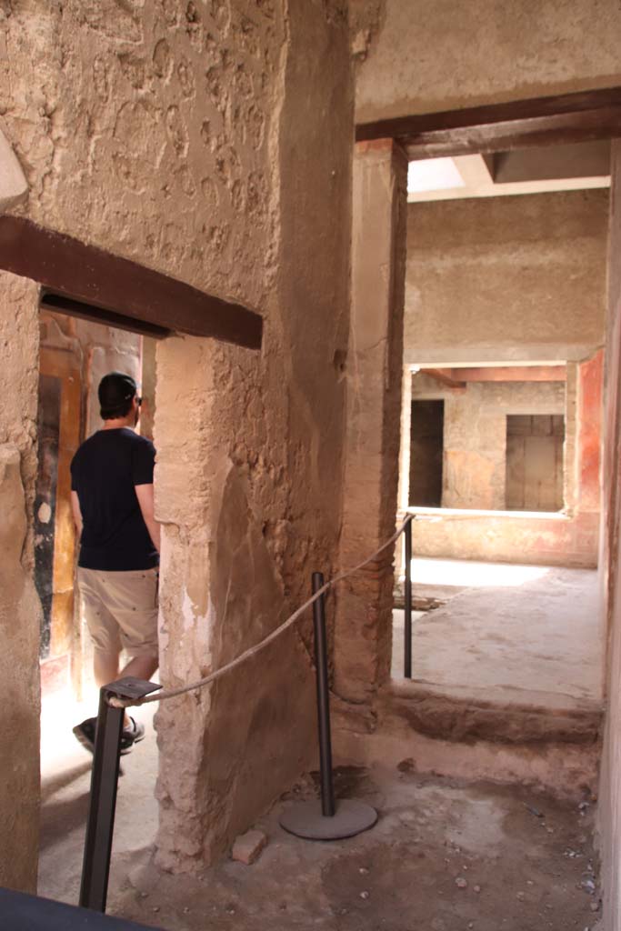 I.7.2 Pompeii. September 2019. Looking south.
On the left is the doorway connecting to the entrance corridor of I.7.3.
On the right, looking south through site of staircase, through a room that would have been under the stairs, into atrium of I.7.3.