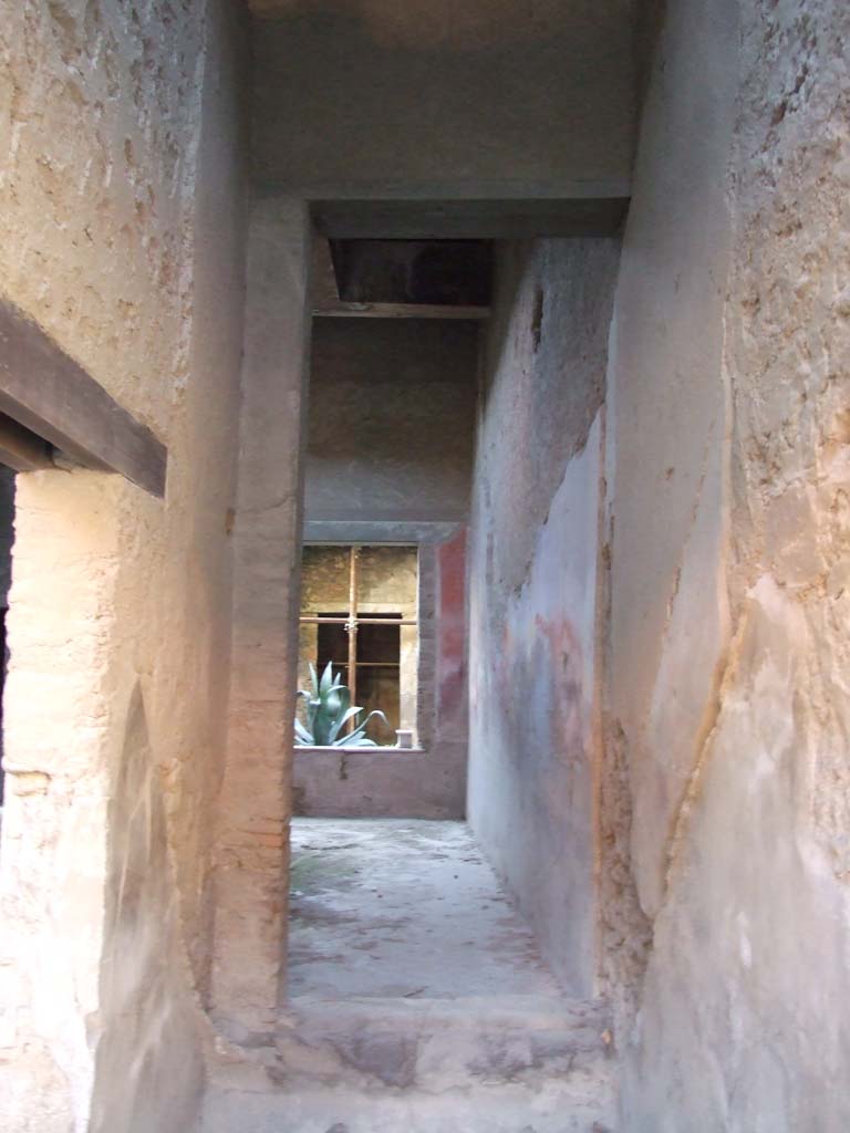 I.7.2 Pompeii. December 2007. Stairway to upper floor at front.  
Looking south through site of staircase, through a room that would have been under the stairs, to atrium of I.7.3.