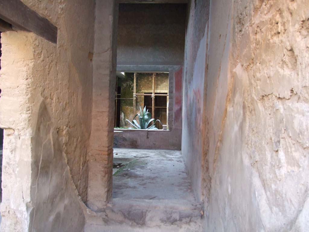 I.7.2 Pompeii. December 2007. Stairway to upper floor at front. 
Looking south through site of staircase, through room under the stairs to atrium of I.7.3.
