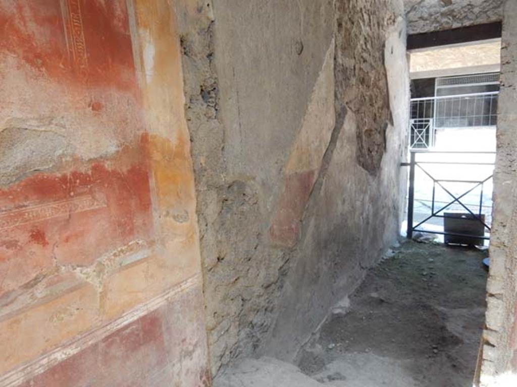 I.7.2/3 Pompeii. May 2016. Looking towards west wall through doorway  in north-west corner of atrium of I.7.3, leading north to entrance at I.7.2, steps to upper floor. 
Photo courtesy of Buzz Ferebee.