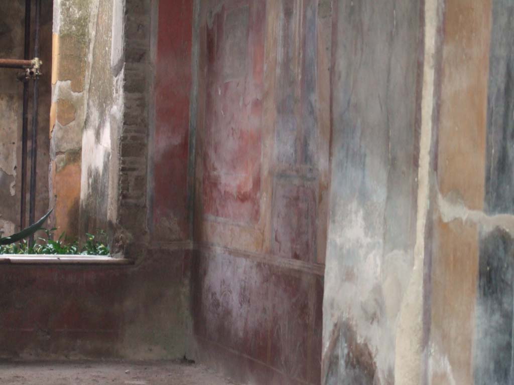 I.7.3 Pompeii. December 2005. West wall of atrium. 
According to Peters, on the left of the west wall was a well-preserved (in 1963) landscape.
He considered the painting very picturesque.
The subject was a temple with a curved roof, standing on a hill against which a tree was growing.
See Peters, W.J.T. (1963): Landscape in Romano-Campanian Mural Paintings. The Netherlands, Van Gorcum & Comp. (p. 153 & fig. 147)
The approximate area of the painting can be seen in the south-west corner, in the upper part of the photo, left of centre.