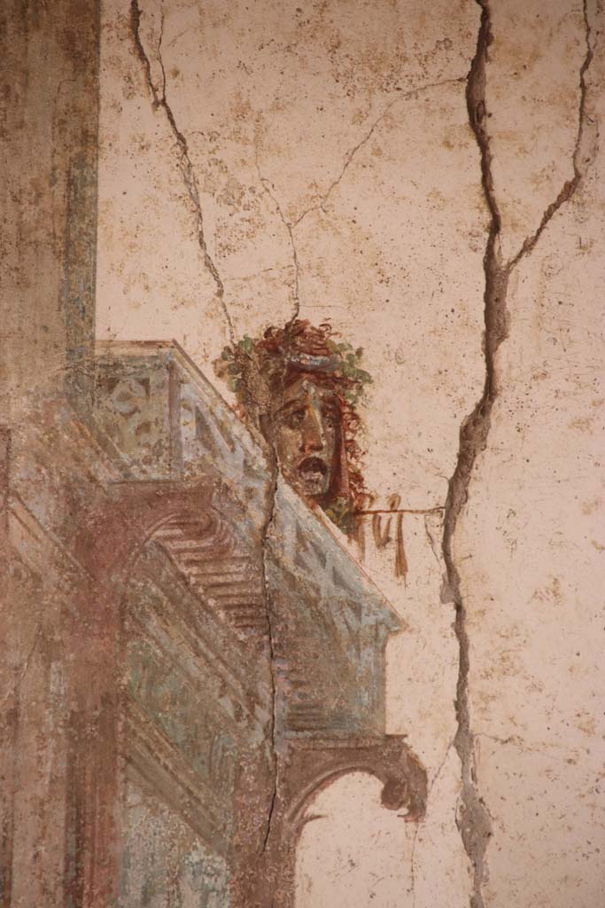 I.7.11 Pompeii. September 2021. 
Detail of painted mask from panel at south end of west wall. Photo courtesy of Klaus Heese.