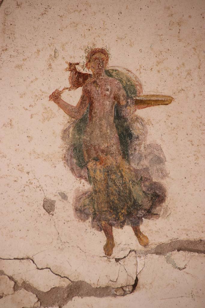 I.7.11 Pompeii. September 2021. 
Detail of painted figure from panel at south end of west wall. Photo courtesy of Klaus Heese.