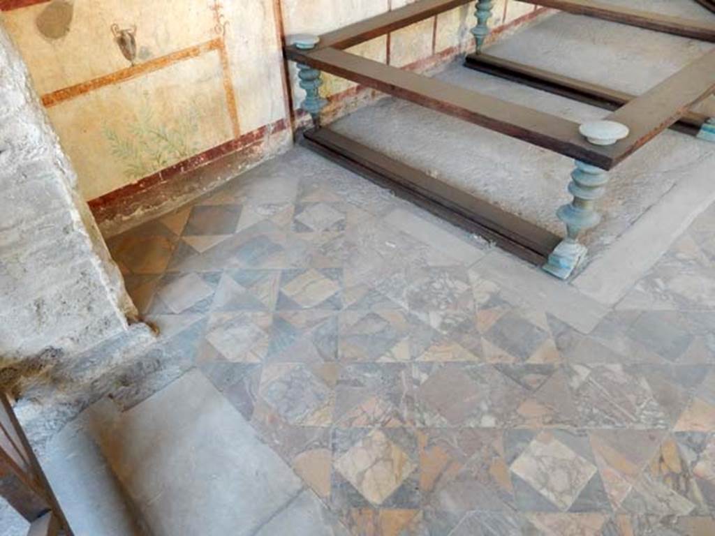 I.7.11 Pompeii. May 2017. Marble tiled floor in south-west corner of triclinium. Photo courtesy of Buzz Ferebee.