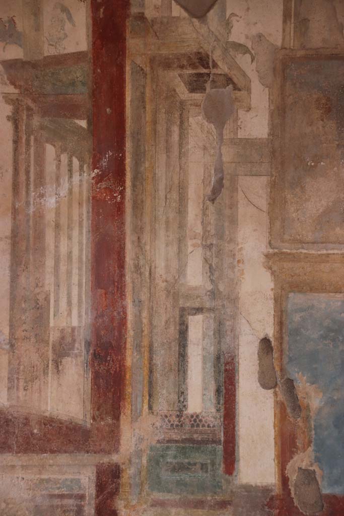 I.7.11 Pompeii. September 2021. 
Detail of painted decoration on west side of central painting on north wall of triclinium. Photo courtesy of Klaus Heese.