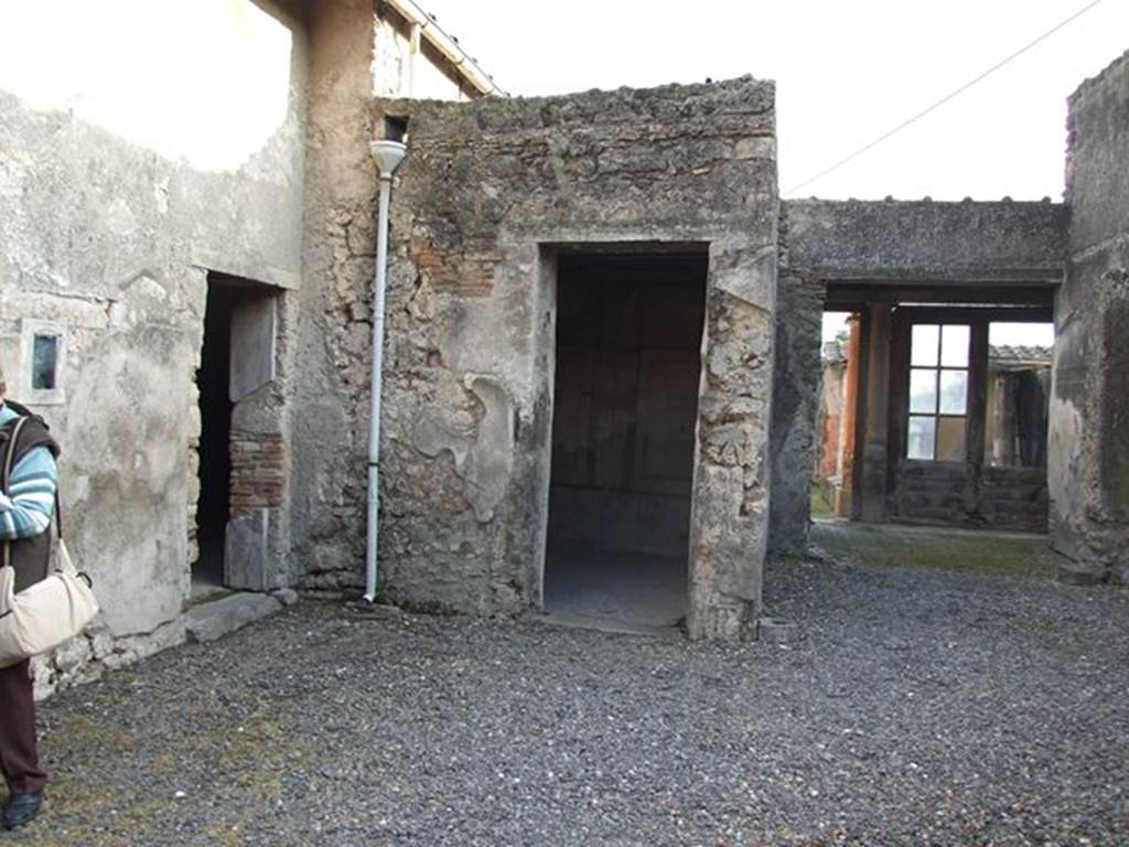 I.7.11 Pompeii. December 2006. Looking south from atrium. 
On the right of the photo can be seen the area of the tablinum, leading to the north portico of the garden area. In the centre is the doorway to a cubiculum to south east of atrium. On the left is the doorway to a triclinium in the south-east corner of the atrium.