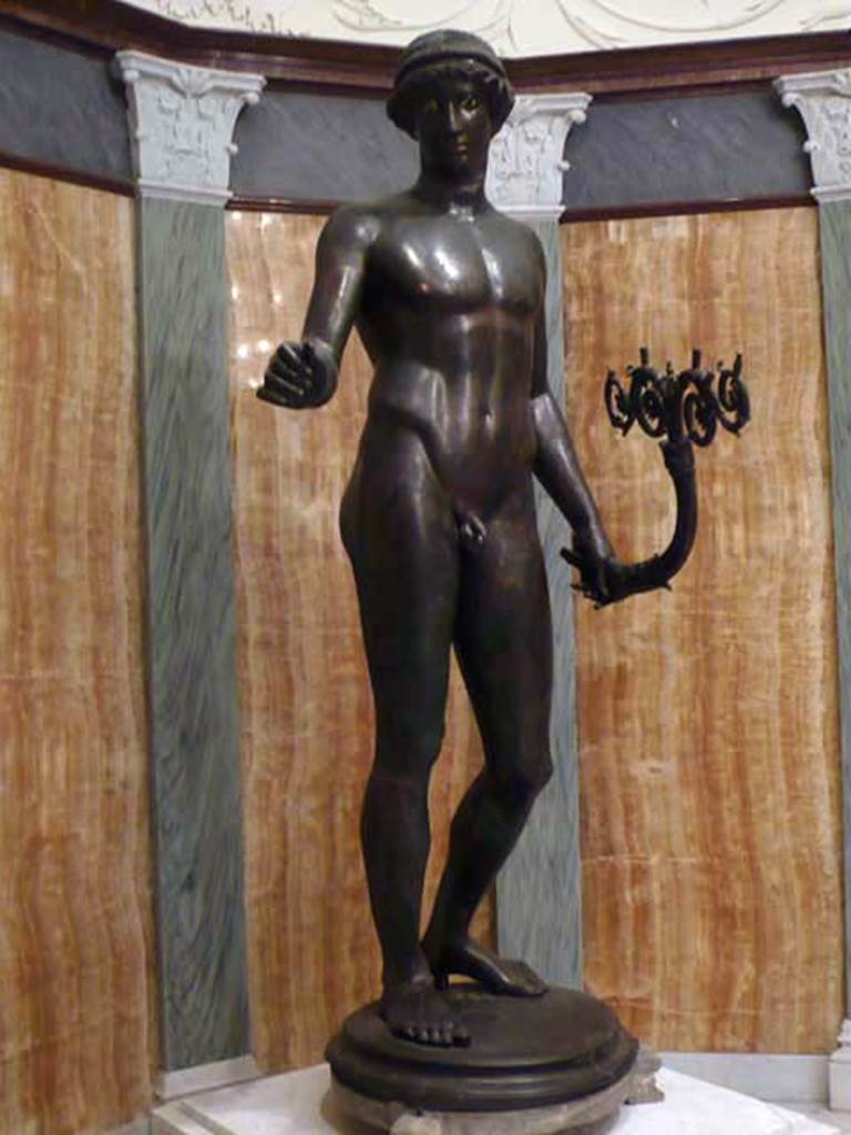 I.7.11 Pompeii. 2010. Left view of bronze statue of the ephebo from south side of atrium near tablinum. 
Photo courtesy of Buzz Ferebee.