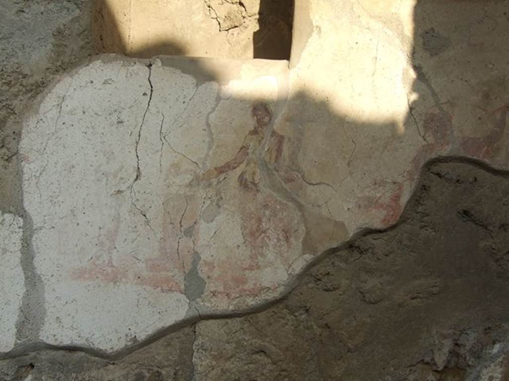 I.7.11 Pompeii. December 2006. Remains of Lararium on east side of atrium belonging to original house I.7.10. According to Boyce, immediately below the niche was the familiar sacrificial scene, flanked by a figure of a Lar on each side. (Only part of the remains of the Lar on the right of the Genius, is visible today)