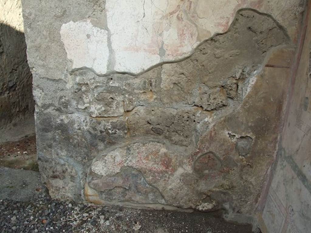 I.7.11 Pompeii. December 2006. Site of lower area of Lararium with painted serpents, not much visible today. According to Boyce, in the zone below the sacrificial scene were two red serpents confronted, one on each side of a circular altar. The altar was furnished with fruits and flowers. The serpent on the right had a red crest and beard, the head of the other was damaged. The background was filled with plants. Not. Scavi, 1927, 38 with photograph.  See Boyce G. K., 1937. Corpus of the Lararia of Pompeii. Rome: MAAR 14. (p.26, no.40)
