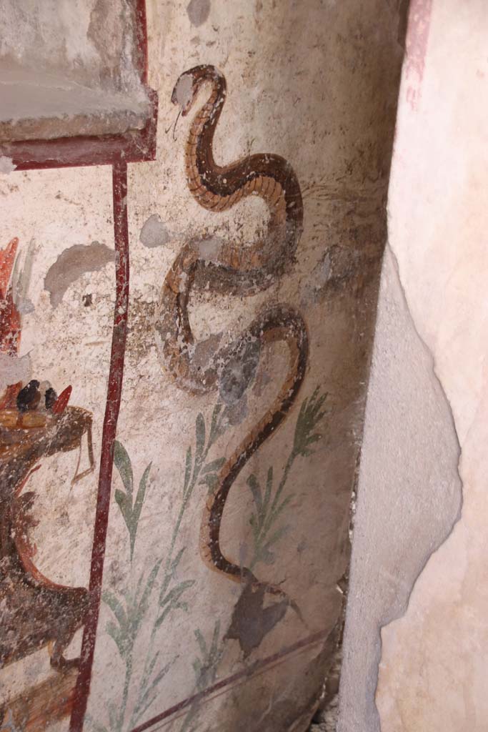 I.7.11 Pompeii. September 2021. 
Painted serpent on north side of painted altar. Photo courtesy of Klaus Heese.