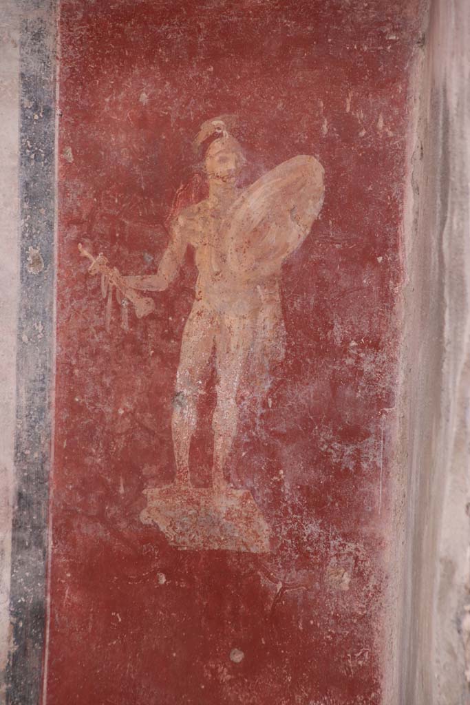 I.7.12 Pompeii. September 2021. 
West end of south wall, detail of figure of a statue of a naked armed warrior.
Photo courtesy of Klaus Heese.