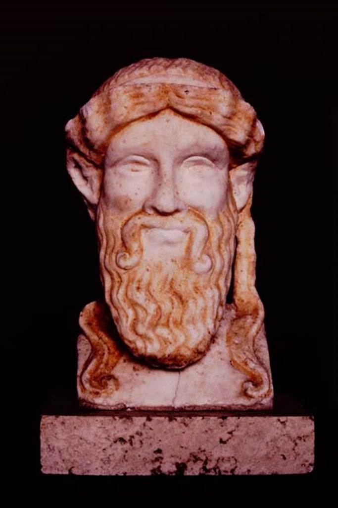 I.7.11 Pompeii, 1982 or 1983. Small sculptured head found on slender posts on east side of garden area.   Source: The Wilhelmina and Stanley A. Jashemski archive in the University of Maryland Library, Special Collections (See collection page) and made available under the Creative Commons Attribution-Non-Commercial License v.4. See Licence and use details.  J80f0490
Wilhelmina described this as “an archaic-style head of Zeus in white marble with lively traces of colour (0.19m high.”
See Jashemski, W. F., 1993. The Gardens of Pompeii, Volume II: Appendices. New York: Caratzas. (p.40)
See Maiuri, A., 1928. Nuovi Scavi nella Via dell’Abbondanza. Milano: Hoepli. (p.73, fig.37).