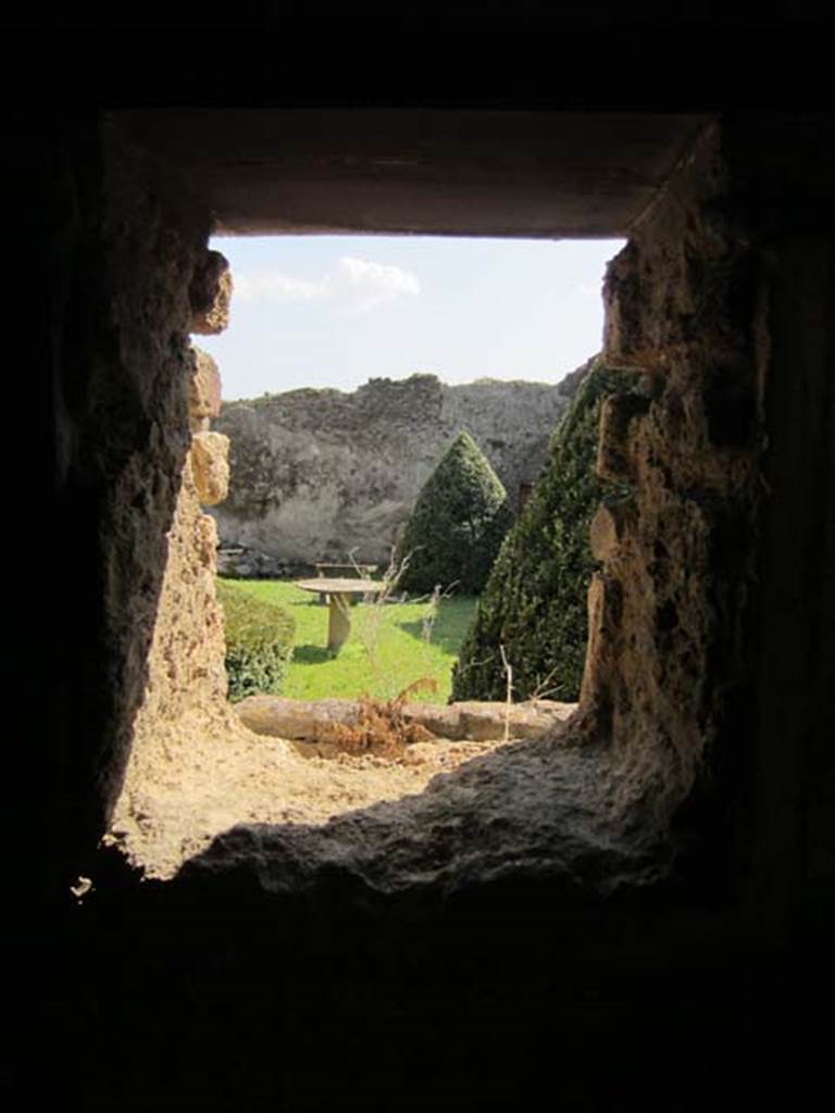 I.7.12 Pompeii. March 2012. Looking through window in south wall, onto garden area. 
Photo courtesy of Marina Fuxa.