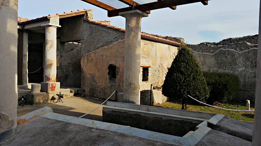 I.7.12 Pompeii. 2015/2016. 
Looking north-east across triclinium in garden towards north portico and window from cubiculum, in centre. Photo courtesy of Giuseppe Ciaramella.