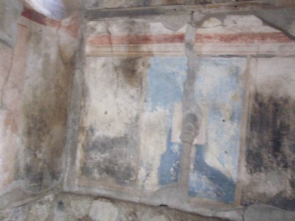 I.7.19 Pompeii. December 2006. East wall of cubiculum on north side of corridor. According to PPM, the east side of the room was reserved for the bed, as indicated by the bed recess in the wall. The alcove was brightened, also, by a circular splayed window which gave light from the small courtyard. The only one of the three painting still legible was that on a black background showing Helen and Paris, which was in the middle of a large pink panel. The corner panels were black.