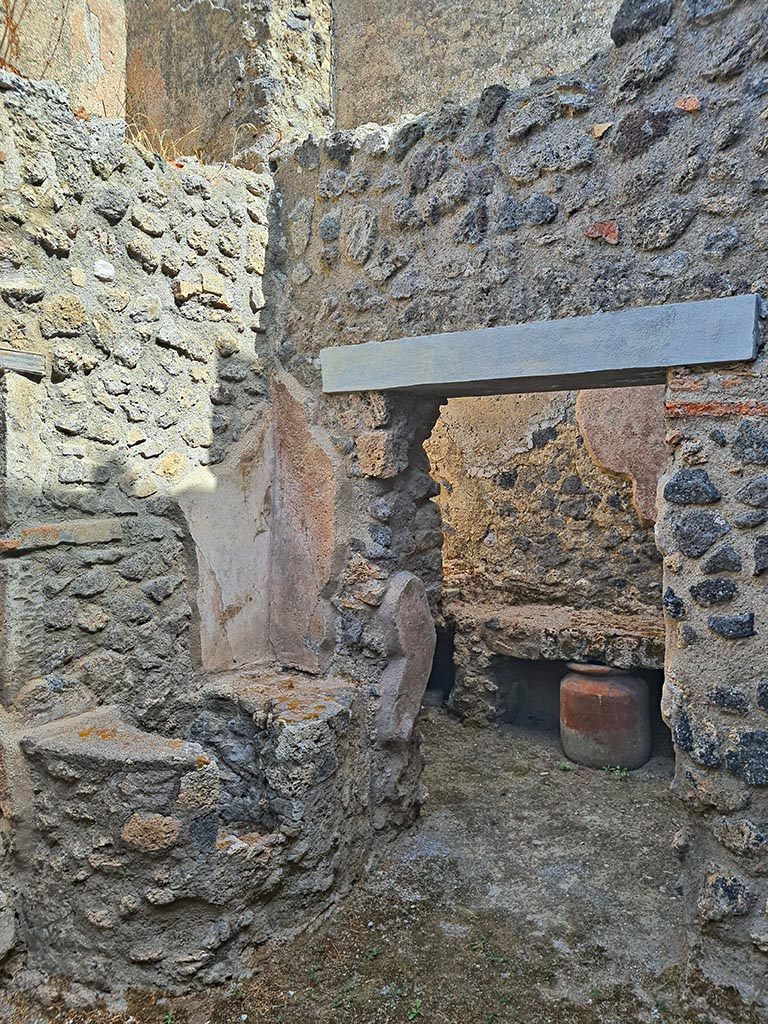 I.7.19 Pompeii. September 2024. 
Looking north-east in second small room on north side of corridor, with doorway to kitchen area, on right. 
Photo courtesy of Giuseppe Ciaramella.