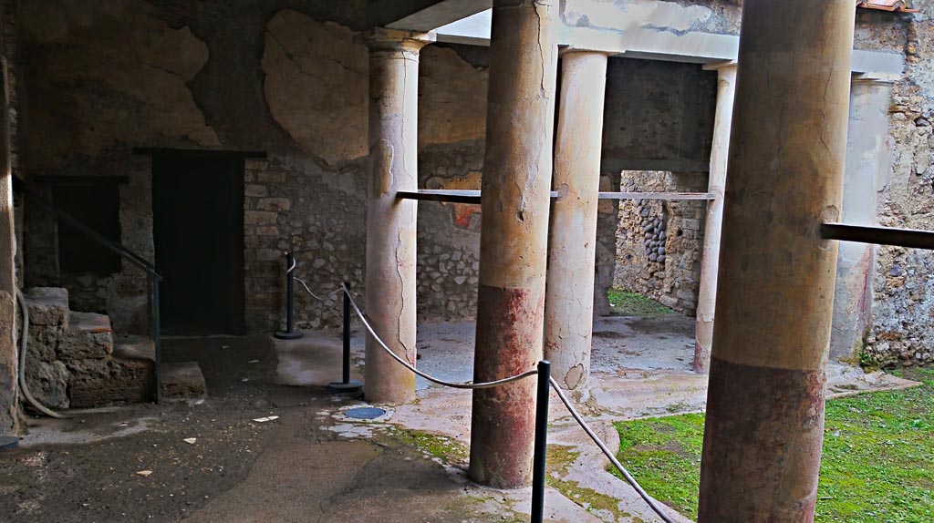 I.7.19 Pompeii. 2017/2018/2019. 
Looking east across north portico of peristyle garden, with steps to I.7.10/11/12, on left. Photo courtesy of Giuseppe Ciaramella.