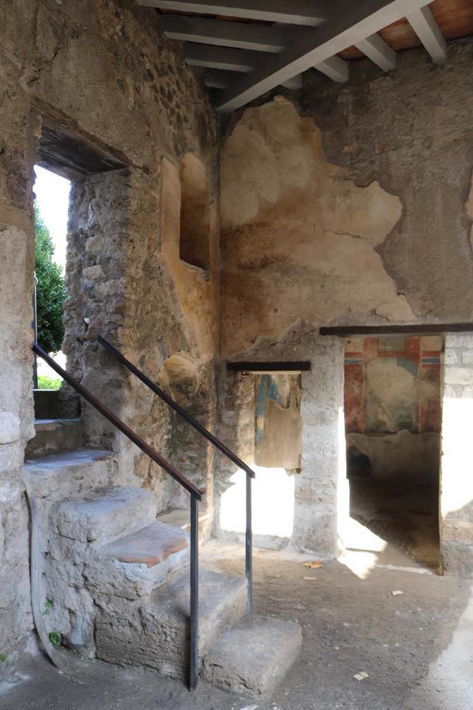 I.7.19 Pompeii. December 2018. 
Looking towards steps up to garden of I.7.12, and doorway to cubiculum in north-east corner of the pseudoperistyle.
Photo courtesy of Aude Durand.